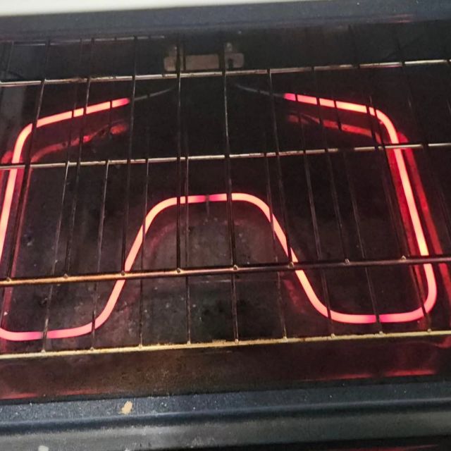 An oven bake element glowing red hot